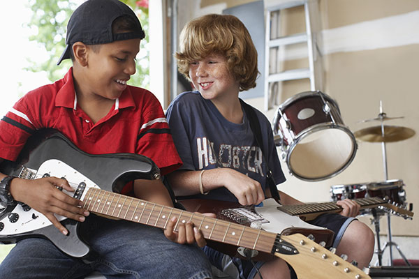 kids playing guitar inside a soundproof garage